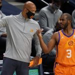 Phoenix Suns coach Monty Williams, left, confers with guard Chris Paul during the first half of the team's NBA basketball game against the Denver Nuggets on Friday, Jan. 1, 2021, in Denver. (AP Photo/David Zalubowski)