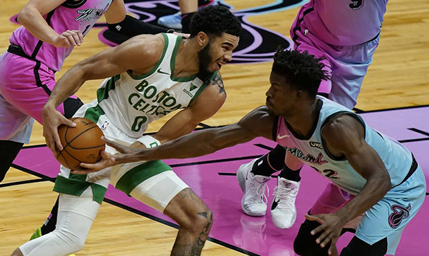 Miami Heat forward Jimmy Butler (22) defends Boston Celtics forward Jayson Tatum (0) during the fir...