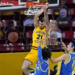 Arizona State forward Chris Osten (21) dunks over UCLA guards Johnny Juzang (3) and Jaime Jaquez Jr. (4) during the second half of an NCAA college basketball game Thursday, Jan. 7, 2021, in Tempe, Ariz. (AP Photo/Ross D. Franklin)