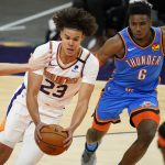 Phoenix Suns forward Cameron Johnson (23) drives as Oklahoma City Thunder guard Hamidou Diallo (6) defends during the second half of an NBA basketball game, Wednesday, Jan. 27, 2021, in Phoenix. (AP Photo/Matt York)