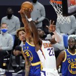 Phoenix Suns center Deandre Ayton (22) shoots as Golden State Warriors guard Kelly Oubre Jr. (12) tries to block but is called for a foul during the second half of an NBA basketball game Thursday, Jan. 28, 2021, in Phoenix. (AP Photo/Matt York)