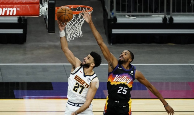 Denver Nuggets guard Jamal Murray (27) drives past Phoenix Suns forward Mikal Bridges during the fi...