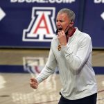 Southern California coach Andy Enfield rects to a basket against Arizona during the first half of an NCAA college basketball game Thursday, Jan. 7, 2021, in Tucson, Ariz. (AP Photo/Rick Scuteri)