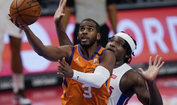 Phoenix Suns guard Chris Paul (3) makes a layup as Detroit Pistons center Isaiah Stewart defends du...