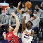 
              Phoenix Suns center Deandre Ayton (22) beats Toronto Raptors center Aron Baynes (46) to the ball on the opening tip-off during the first half of an NBA basketball game Wednesday, Jan. 6, 2021, in Phoenix. (AP Photo/Ross D. Franklin)
            