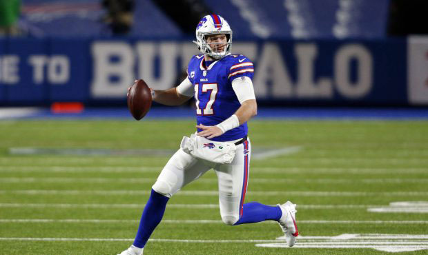 Buffalo Bills' Josh Allen (17) rushes during the first half of an NFL divisional round football gam...