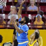 UCLA forward Cody Riley gets past Arizona State forward Kimani Lawrence, right, to score during the first half of an NCAA college basketball game Thursday, Jan. 7, 2021, in Tempe, Ariz. (AP Photo/Ross D. Franklin)