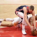 Washington Wizards center Moritz Wagner, left, and Phoenix Suns guard Devin Booker, right, battle for the ball during the first half of an NBA basketball game, Monday, Jan. 11, 2021, in Washington. (AP Photo/Nick Wass)