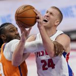 Detroit Pistons center Mason Plumlee (24) is fouled by Phoenix Suns forward Jae Crowder during the second half of an NBA basketball game, Friday, Jan. 8, 2021, in Detroit. (AP Photo/Carlos Osorio)