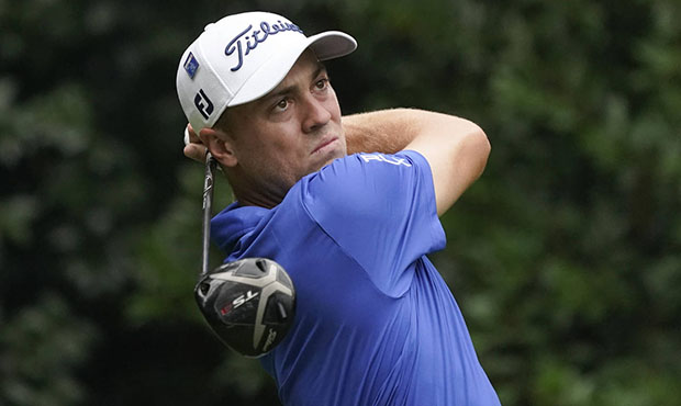 Justin Thomas watches his tee shot on the 11th hole during a practice round at the Masters golf tou...