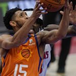 Phoenix Suns guard Cameron Payne (15) makes a layup as Detroit Pistons center Isaiah Stewart defends during the first half of an NBA basketball game Friday, Jan. 8, 2021, in Detroit. (AP Photo/Carlos Osorio)