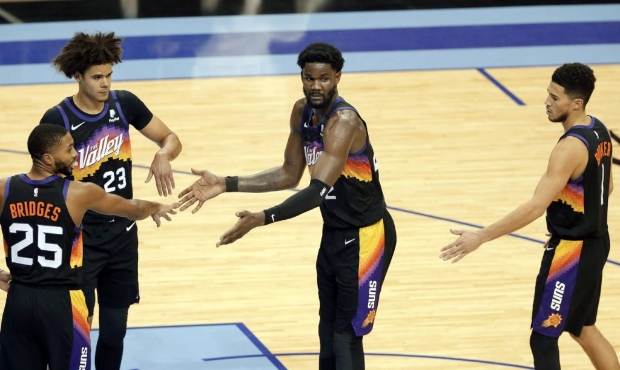 Phoenix Suns center Deandre Ayton, middle, is congratulated by Mikal Bridges (25), Cameron Johnson ...