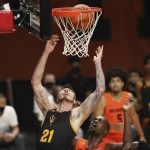 Arizona State's Chris Osten (21) lets go of the rim after dunking as Oregon State's Dearon Tucker, bottom, watches during the first half of an NCAA college basketball game in Corvallis, Ore., Saturday, Jan. 16, 2021. (AP Photo/Amanda Loman)