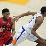 Phoenix Suns forward Mikal Bridges, right, dribbles past Toronto Raptors guard Kyle Lowry (7) during the second half of an NBA basketball game Wednesday, Jan. 6, 2021, in Phoenix. The Suns defeated the Raptors 123-115. (AP Photo/Ross D. Franklin)