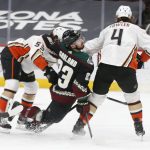 After shooting, Arizona Coyotes' Conor Garland (83) gets sandwiched between Anaheim Ducks' Max Comtois (53) and Cam Fowler (4) during the second period of an NHL hockey game Thursday, Jan. 28, 2021, in Glendale, Ariz. (AP Photo/Darryl Webb)