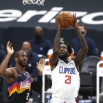 Los Angeles Clippers guard Patrick Beverley (21) shoots past the defense of Phoenix Suns guard Chris Paul (3) during the first half of an NBA basketball game Sunday, Jan. 3, 2021, in Phoenix. (AP Photo/Ralph Freso)