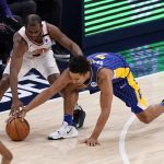 Indiana Pacers guard Malcolm Brogdon (7) and Phoenix Suns' Chris Paul (3) battle for the ball during the second half of an NBA basketball game, Saturday, Jan. 9, 2021, in Indianapolis. (AP Photo/Darron Cummings)