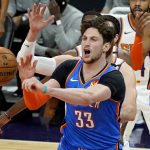 Oklahoma City Thunder center Mike Muscala (33) passes under pressure against the Phoenix Suns during the first half of an NBA basketball game, Wednesday, Jan. 27, 2021, in Phoenix. (AP Photo/Matt York)