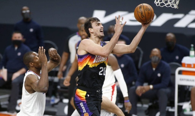 Phoenix Suns forward Dario Saric (20) drives to the basket past the defense of as Los Angeles Clipp...