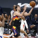 Phoenix Suns forward Dario Saric (20) drives to the basket past the defense of as Los Angeles Clippers center Serge Ibaka, left, during the second half of an NBA basketball game Sunday, Jan. 3, 2021, in Phoenix. (AP Photo/Ralph Freso)