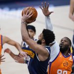 Denver Nuggets guard Jamal Murray puts up a last-second, 3-point shot that missed, as Phoenix Suns forward Jae Crowder defends during an NBA basketball game Friday, Jan. 1, 2021, in Denver. The Suns won 106-103. (AP Photo/David Zalubowski)