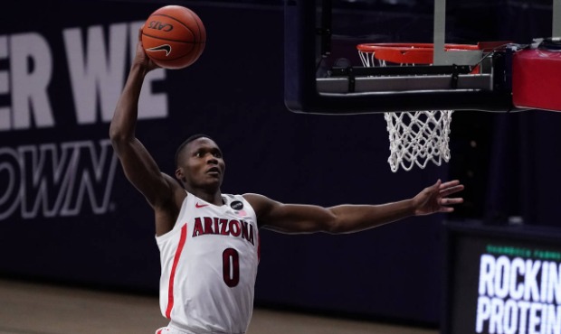 Arizona guard Bennedict Mathurin (0) dunks against Arizona State during the first half of an NCAA c...