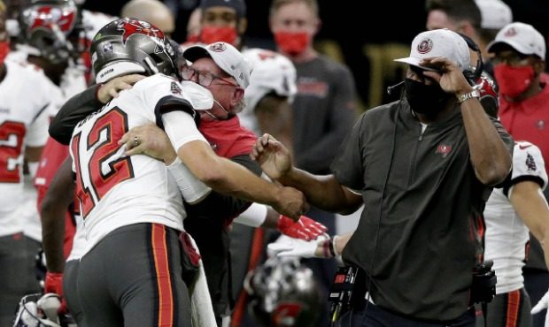 Tampa Bay Buccaneers quarterback Tom Brady (12) hugs head coach Bruce Arians on the sidelines durin...