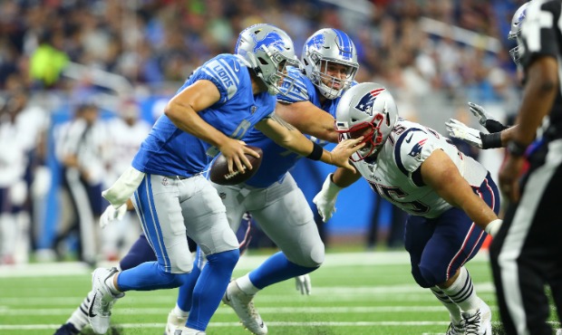 David Parry #75 of the New England Patriots sacks David Fales #8 of the Detroit Lions in the second...