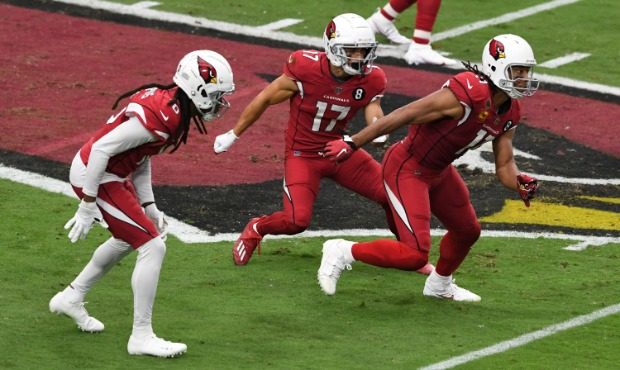 Larry Fitzgerald #11, Andy Isabella #17 and DeAndre Hopkins #10 of the Arizona Cardinals run a pass...
