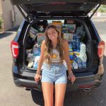 Madilyn on her 17th birthday with the donations she gathered for a domestic violence shelter. (Courtesy of Scott family)