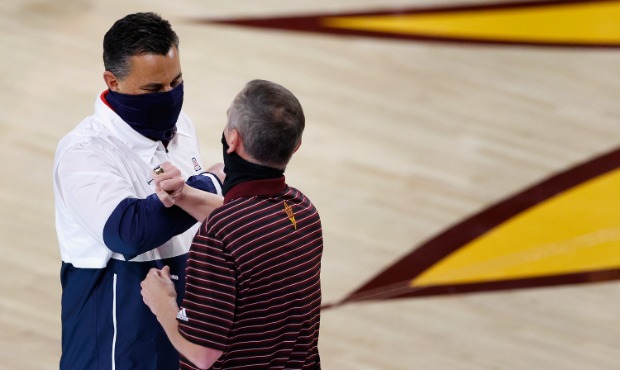 Head coaches Sean Miller of the Arizona Wildcats and Bobby Hurley of the Arizona State Sun Devils g...