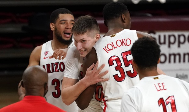 Arizona forward Azuolas Tubelis (10) celebrates with teammates after tipping in a basket at the buz...
