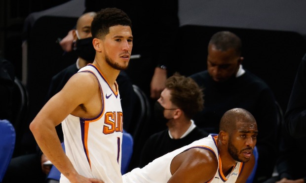 Devin Booker #1 and Chris Paul #3 of the Phoenix Suns look down court during the second half of the...
