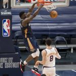 New Orleans Pelicans forward Zion Williamson (1) dunks over Phoenix Suns forward Frank Kaminsky (8) in the third quarter of an NBA basketball game in New Orleans, Wednesday, Feb. 3, 2021. (AP Photo/Derick Hingle)