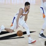 
              Phoenix Suns guard Devin Booker (1) looks to pass against the Cleveland Cavaliers during the second half of an NBA basketball game, Monday, Feb. 8, 2021, in Phoenix. (AP Photo/Matt York)
            