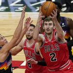 Chicago Bulls forward Luke Kornet, right, battles for a rebound against Phoenix Suns guard Devin Booker during the first half of an NBA basketball game in Chicago, Friday, Feb. 26, 2021. (AP Photo/Nam Y. Huh)