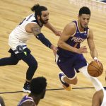 Phoenix Suns' Devin Booker (1) drives the ball past Minnesota Timberwolves' Ricky Rubio (9) in the first half of an NBA basketball game, Sunday, Feb. 28, 2021, in Minneapolis. (AP Photo/Stacy Bengs)