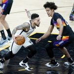 Brooklyn Nets guard Chris Chiozza drives as Phoenix Suns forward Cameron Johnson defends during the first half of an NBA basketball game, Tuesday, Feb. 16, 2021, in Phoenix.(AP Photo/Matt York)