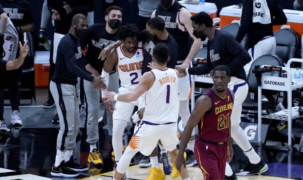 Phoenix Suns guard Langston Galloway (2) celebrates with teammates and guard Devin Booker (1) after...