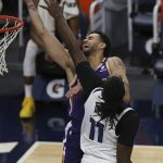 Phoenix Suns' Abdel Nader (11) is fouled by Minnesota Timberwolves's Naz Reid (11) in the second half of an NBA basketball game Sunday, Feb. 28, 2021, in Minneapolis. (AP Photo/Stacy Bengs)