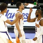 Phoenix Suns' Cam Johnson (23) Devin Booker (1) and Chris Paul (3) celebrate Johnson's last-second three-point basket during the second half of an NBA basketball game against the Portland Trail Blazers, Monday, Feb. 22, 2021, in Phoenix. (AP Photo/Darryl Webb)