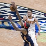 New Orleans Pelicans forward Brandon Ingram (14) knocks away a pass by Phoenix Suns guard Devin Booker (1) in the third quarter of an NBA basketball game in New Orleans, Wednesday, Feb. 3, 2021. (AP Photo/Derick Hingle)
