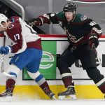 Colorado Avalanche center Tyson Jost (17) keeps the puck away from Arizona Coyotes defenseman Ilya Lyubushkin (46) during the first period of an NHL hockey game Friday, Feb. 26, 2021, in Glendale, Ariz. (AP Photo/Ross D. Franklin)