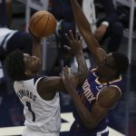 Minnesota Timberwolves's Anthony Edwards (1) goes up to the basket against Phoenix Suns' Jalen Smith (10) in the second half of an NBA basketball game Sunday, Feb. 28, 2021, in Minneapolis. (AP Photo/Stacy Bengs)