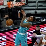 Charlotte Hornets guard Malik Monk (1) dunks against the Phoenix Suns during the second half of an NBA basketball game, Wednesday, Feb. 24, 2021, in Phoenix. (AP Photo/Matt York)