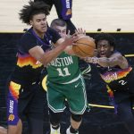 Phoenix Suns forward Cam Johnson, right, and guard Langston Galloway (2) battle for control of a loose ball with Boston Celtics guard Payton Pritchard (11) during the second half of an NBA basketball game, Sunday, Feb. 7, 2021, in Phoenix. (AP Photo/Ralph Freso)