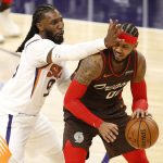 Phoenix Suns' Jae Crowder get his hand in the face of Portland Trail Blazers' Carmelo Anthony during the second half of an NBA basketball game Monday, Feb. 22, 2021, in Phoenix. Crowder got called for a flagrant foul on the play (AP Photo/Darryl Webb)