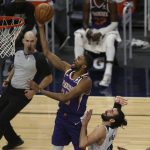 Phoenix Suns' Mikal Bridges (25) goes up to the basket past Minnesota Timberwolves's Ricky Rubio (9) in the second half of an NBA basketball game Sunday, Feb. 28, 2021, in Minneapolis. (AP Photo/Stacy Bengs)