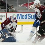 Colorado Avalanche goaltender Hunter Miska (32) makes a save as Arizona Coyotes right wing Clayton Keller (9) and Avalanche defenseman Devon Toews, second from right, look on during the first period of an NHL hockey game Friday, Feb. 26, 2021, in Glendale, Ariz. (AP Photo/Ross D. Franklin)