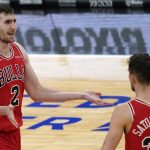 Chicago Bulls forward Luke Kornet, left, celebrates with guard Tomas Satoransky after making a three-point basket during the second half of an NBA basketball game against the Phoenix Suns in Chicago, Friday, Feb. 26, 2021. (AP Photo/Nam Y. Huh)
